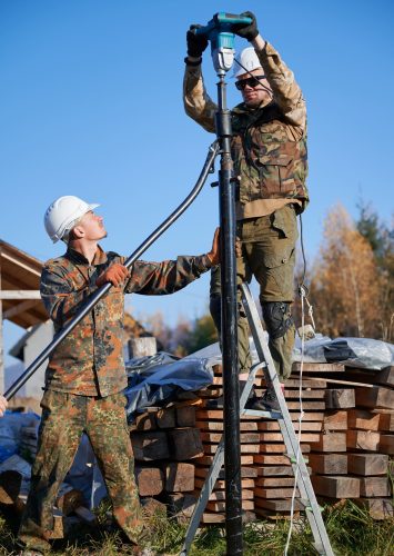 male-workers-building-pile-foundation-for-wooden-f-2026-03-17-02-14-10-utc (1)